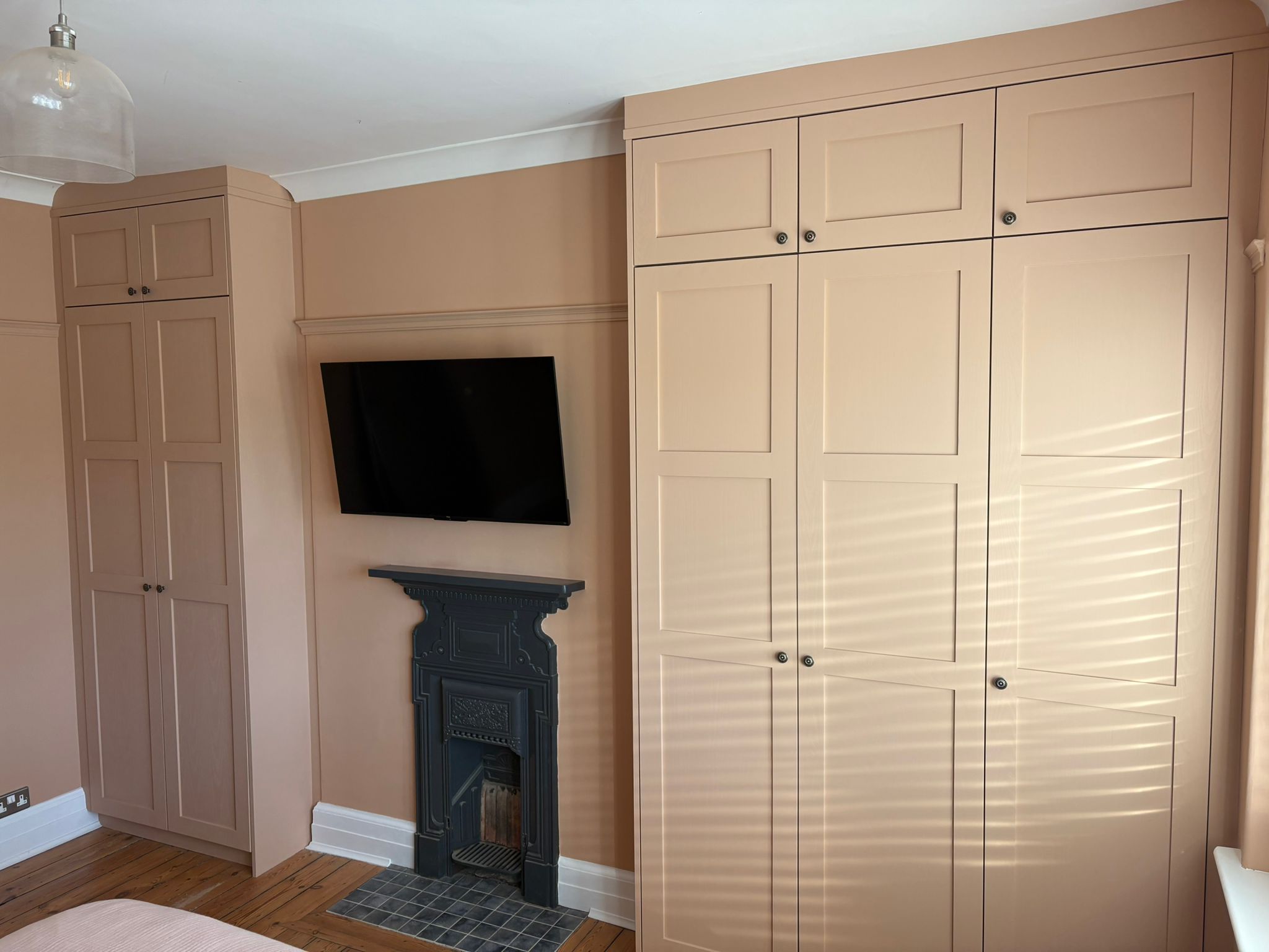 Bedroom with custom wardrobe fronts in solid Ash